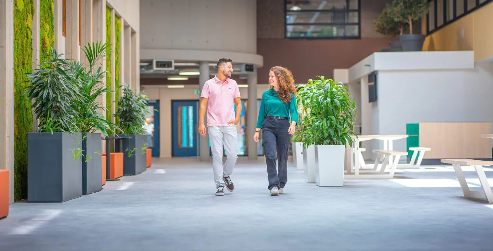 2 Studenten lopen over de gang op een locatie van MBO Utrecht tijdens een studiekeuze-event.